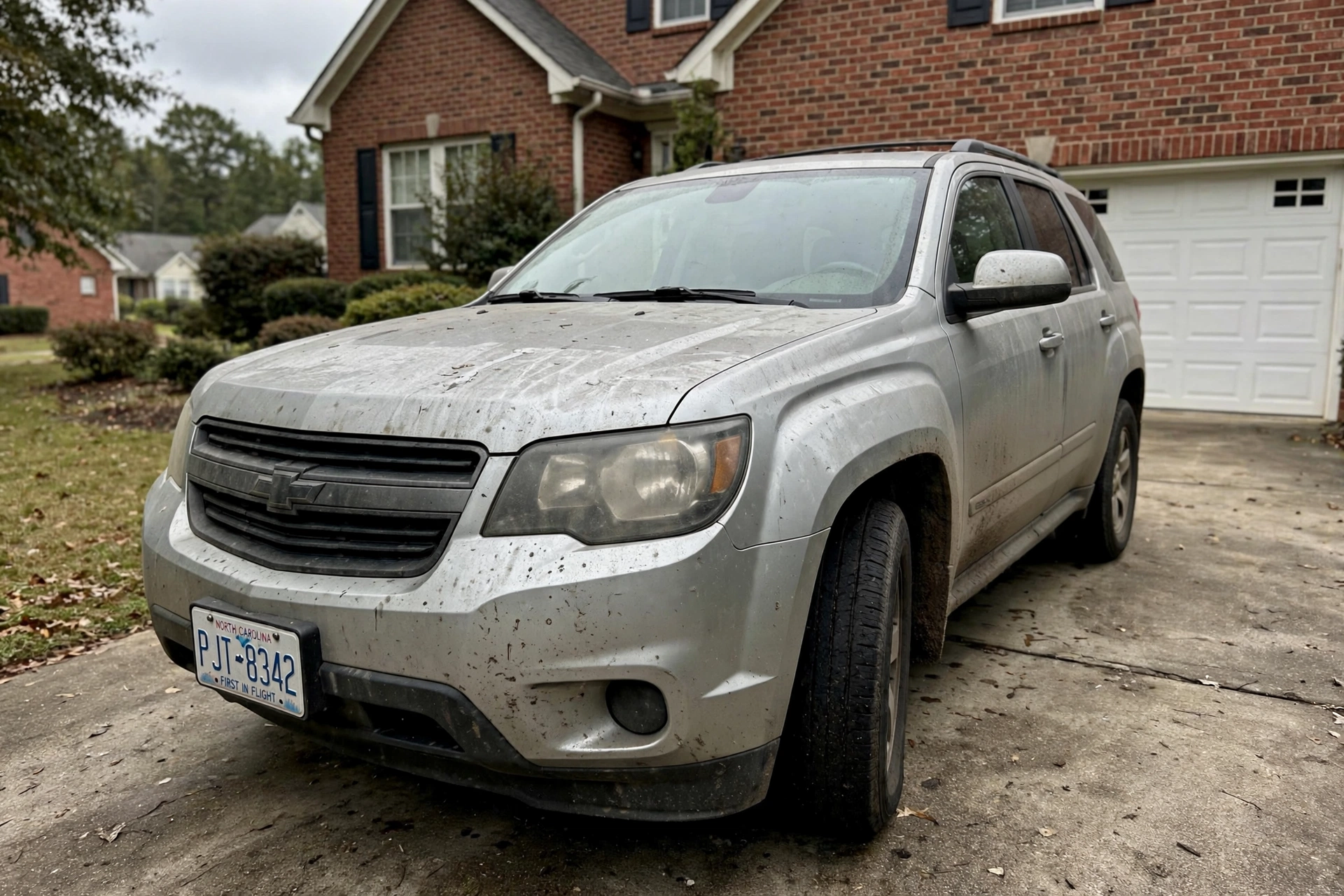 Silver SUV before detailing in Charlotte suburb — illustrative example