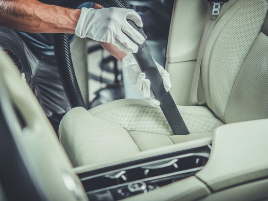 Technician deep-vacuuming a car interior during an interior detail in Indianapolis