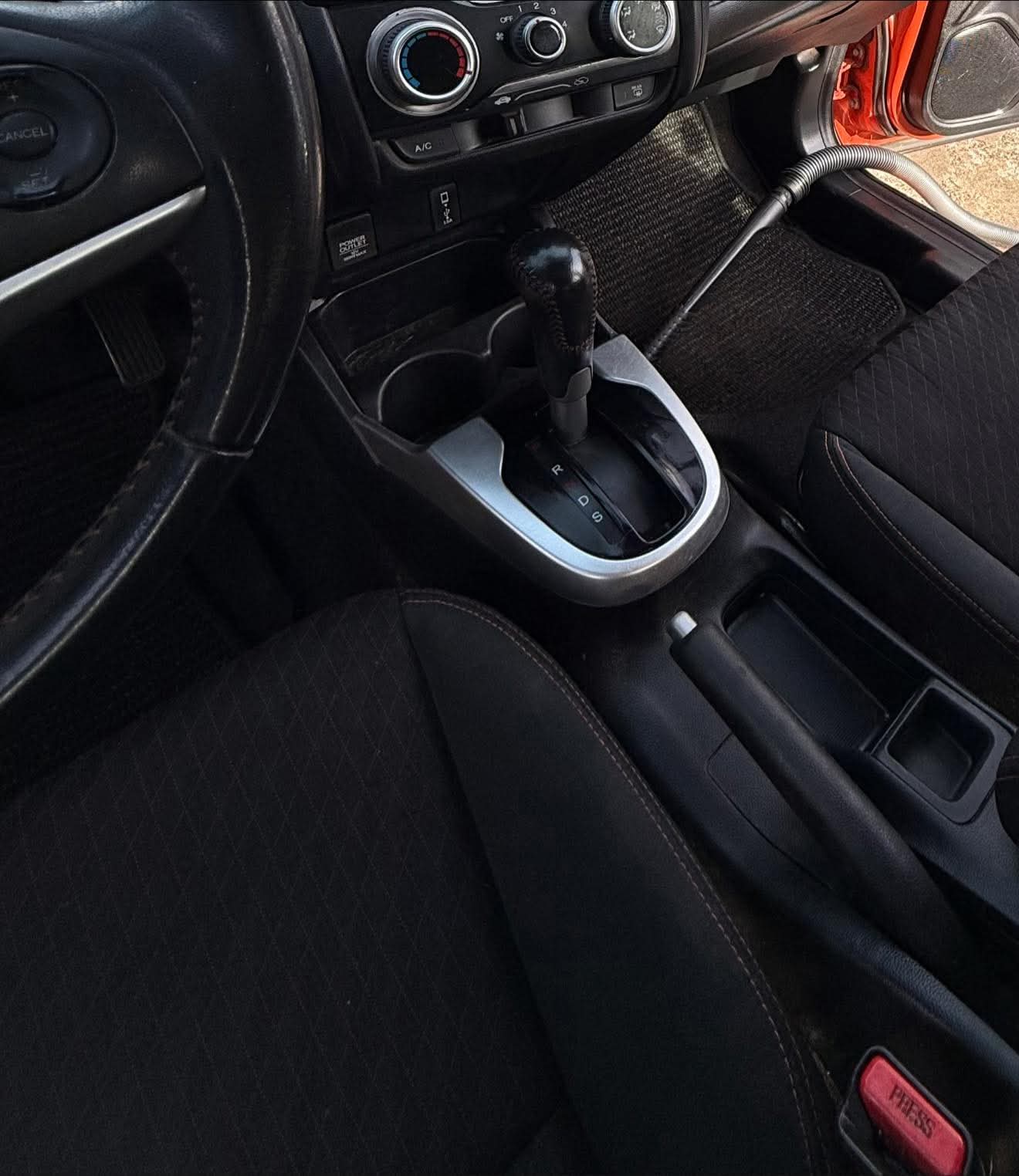 Real job: clean center console, gear shift and seats of a red Honda after an interior detail