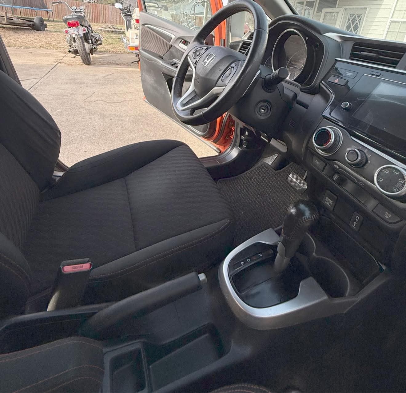 Real job: freshly detailed driver area — clean fabric seat, steering wheel and dashboard